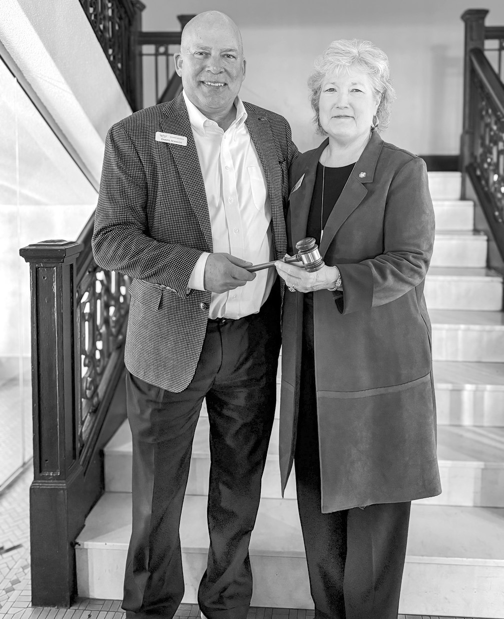 BancFirst President and CEO Darryl Schmidt (left) passes the gavel to Seminole State College President Lana Reynolds (right) as Reynolds assumes the role of 2026 Oklahoma Academy chair during the Academy’s annual business meeting Jan. 16 in Oklahoma Cit