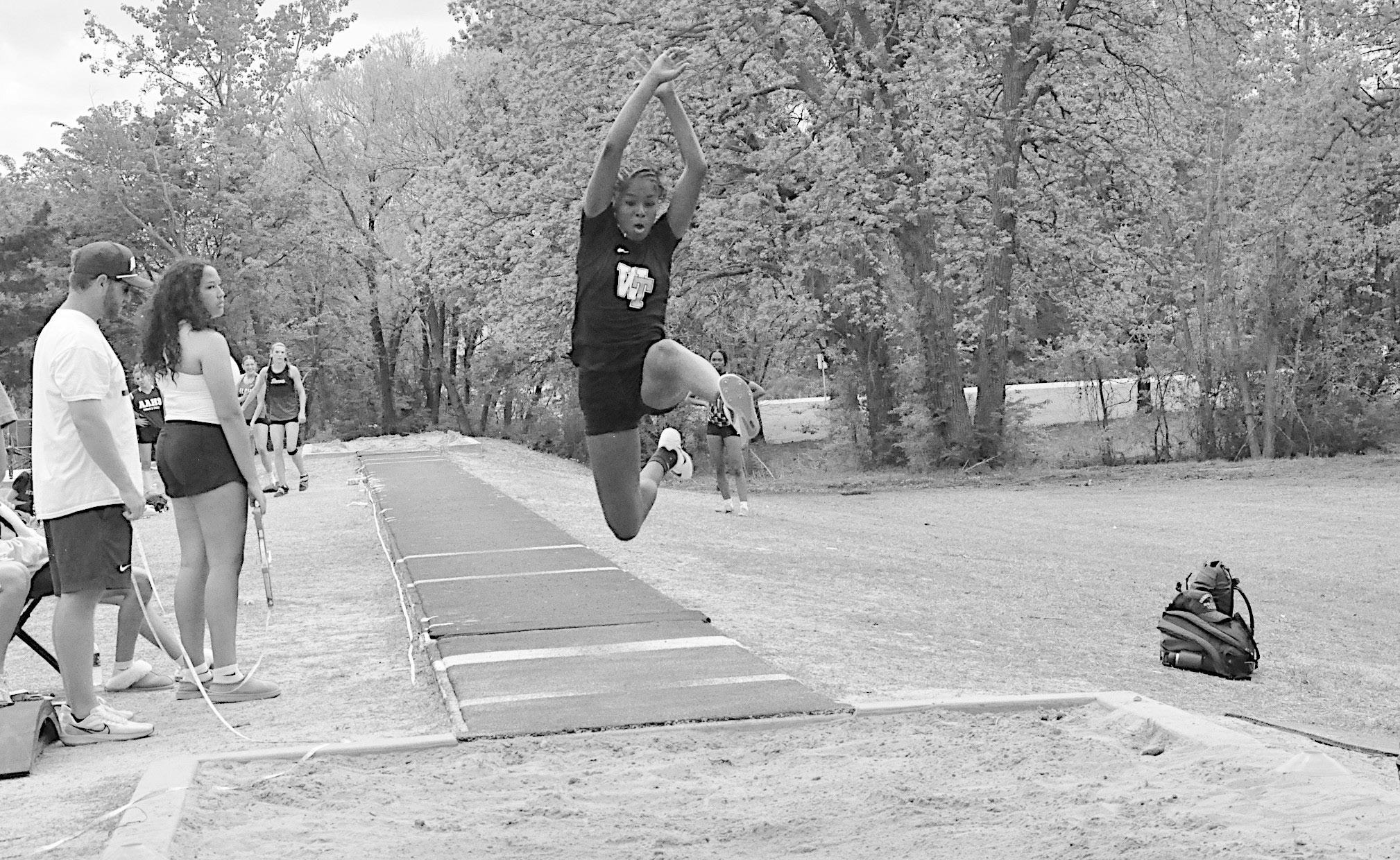 Wewoka Lady Tiger Heavenli Hill leaps into the air during the Long Jump event at Ada. Heavenli Hill placed 2nd Overall with a jump of 16’ 10”. Staff Photo by Bill Anderson