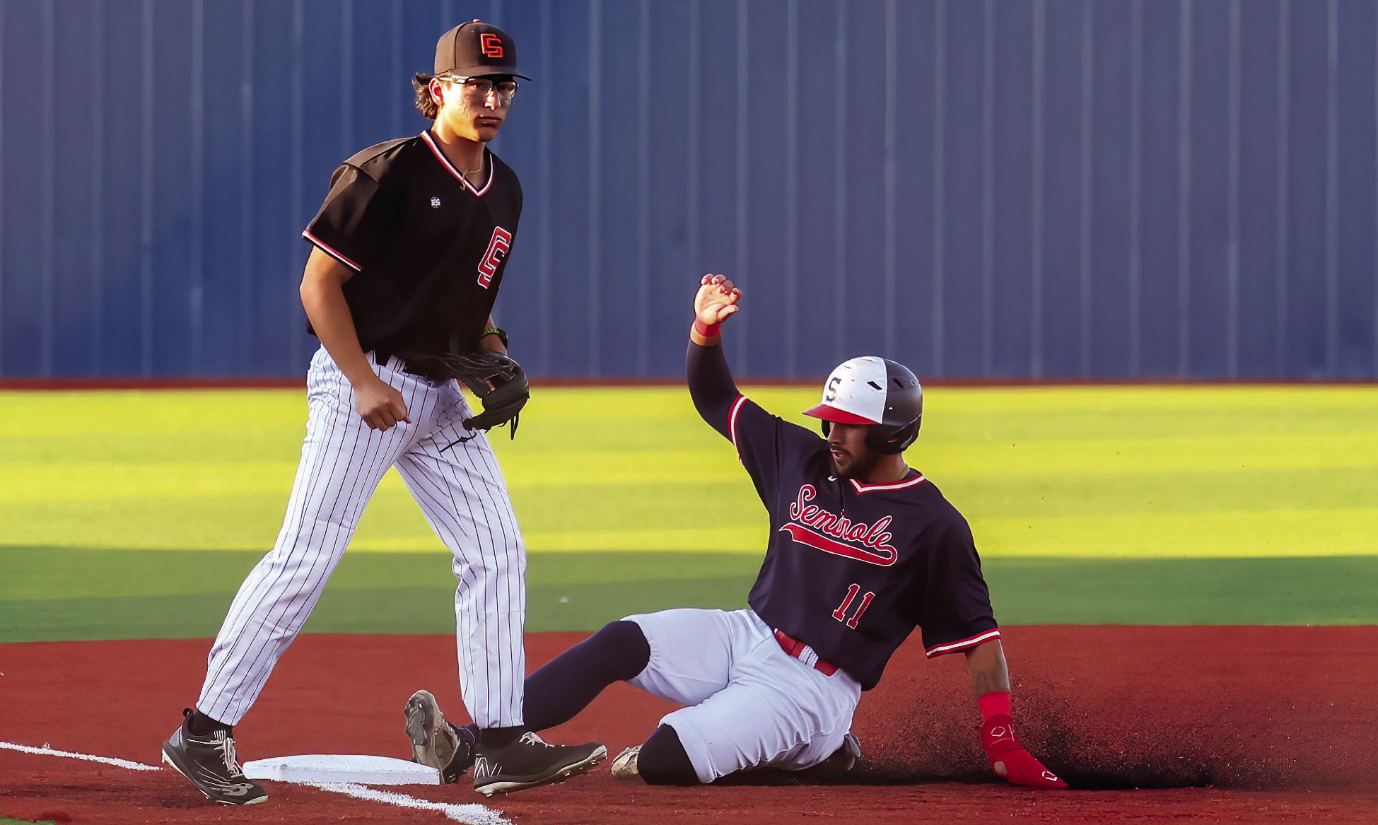 Seminole State Trojan Hunter Dearman slides safely at 3rd base Thursday night. CourtesayPhotobyGlenBryan