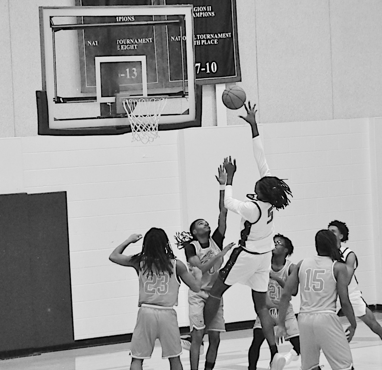 Seminole State Trojan Jaylan Jackson goes up and over the Langston defenders for the shot. Staff Photo by Bill Anderson