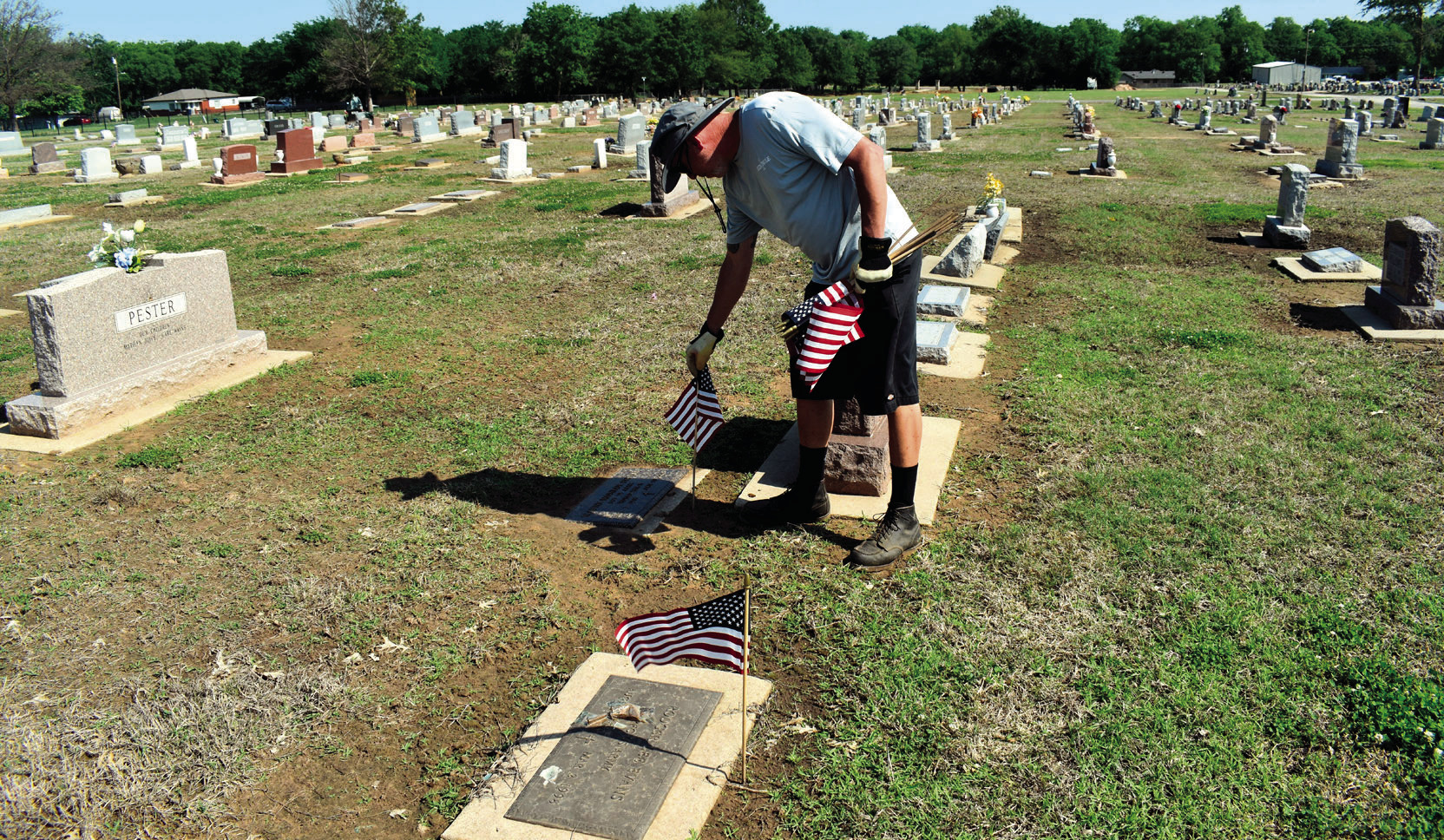 A worker for the City of Seminole places flags on the graves of veterans in Maple Grove Cemetery on Friday. A special Memorial Day service will be held on Monday, May 26 beginning at 10 a.m. in the historic O.D. Strother Chapel. Brigadier General Brad Car
