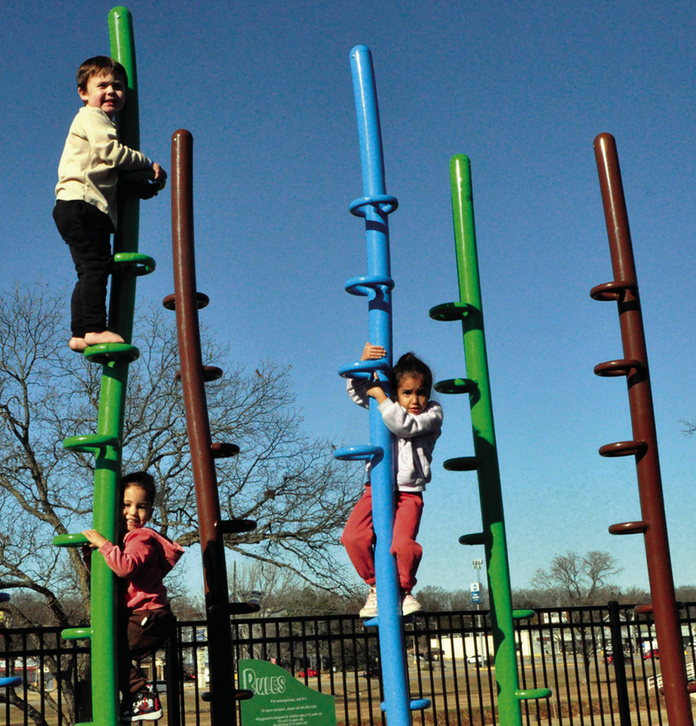 Chance Morgan, Royalty Moore and Joey Moore took advantage of Wednesday’s unseasonably warm temperatures by climbing around in Boom Town Playground, located in the Seminole Municipal Park. —Staff Photo by Bill Anderson
