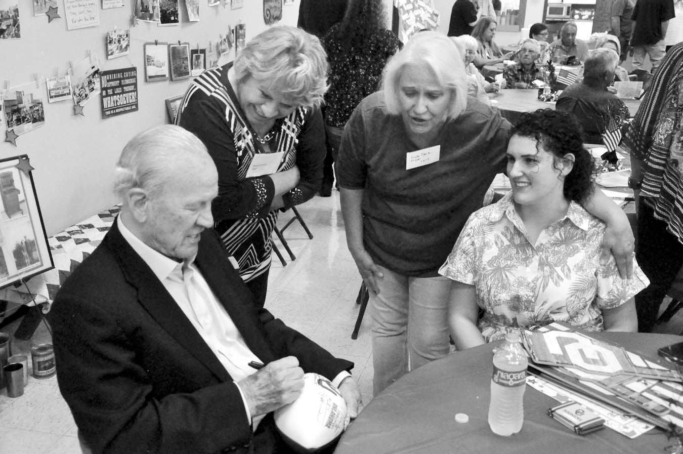 Former University of Oklahoma Football Coach Barry Switzer signs footballs for attendees of the 2025 Maud Alumni Reunion held Saturday evening, June 14 at the Maud Community Center. Event organizers said about 250 people attended the reunion, surpassing t