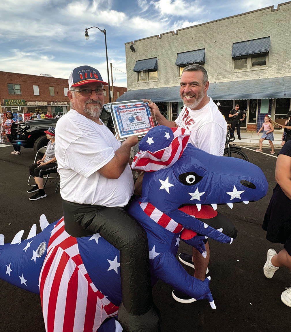 Seminole City Councilman Scott Rossman, who represents Ward Two, won second place for creativity at the “Happy Birthday USA” block party Tuesday evening, sponsored by the Seminole Arts Council. Pictured with Rossman is Mayor Cory Crabtree. —Courtesy