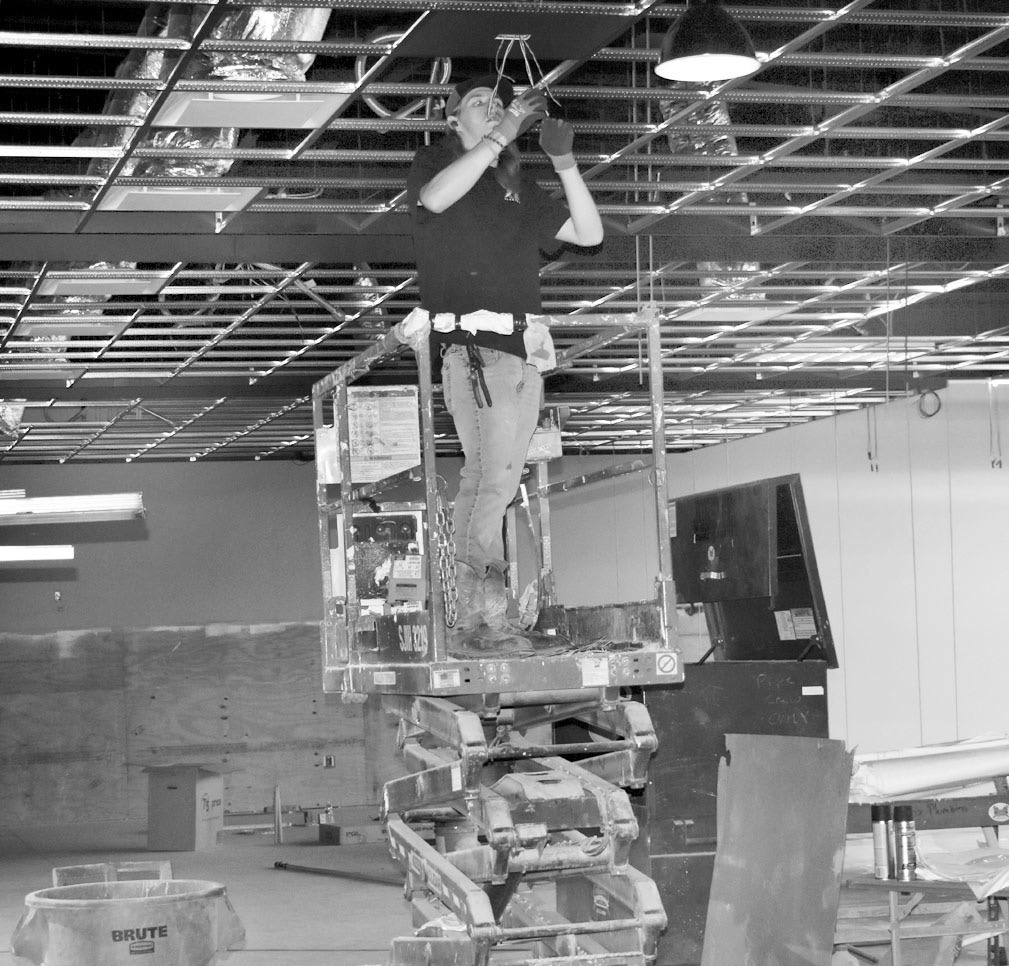 A worker perches atop a forklift Monday inside the future Hey Seminole Entertainment Center on Highway 9, operated by HeyDay Entertainment. On Monday, the company announced that its Norman location would close at the end of this month. —Staff Photo by Andy Wilson