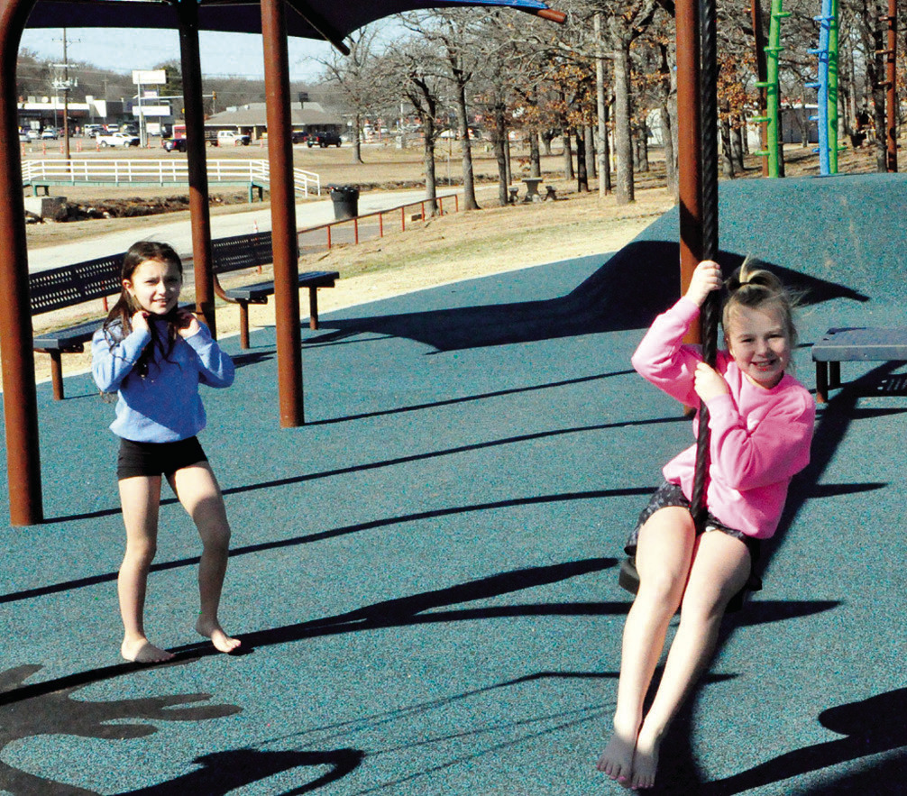 Sophia Hines and Tatum Batchelor, both barefoot and clad in shorts, ventured out Friday afternoon to swing and grab some sunshine at Boom Town. Should they do so again this weekend, their feet might be a little warmer, as temps in the 60s are in the forec
