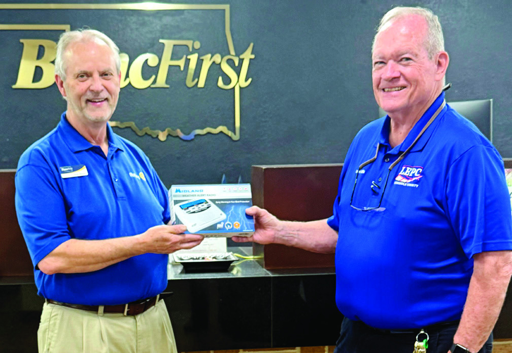 Chris Moore (left), at the most recent Chamber of Commerce Forum, won the Weather Radio given away by Ernie Willis, Emergency Management Director for the City of Seminole. The giveaway was to promote importance of having multiple ways to receive warnings.