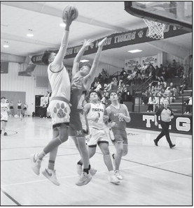 Maud Tiger Treat Marshall goes up and over his defender for the basket. Staff Photo by Andy Wilson