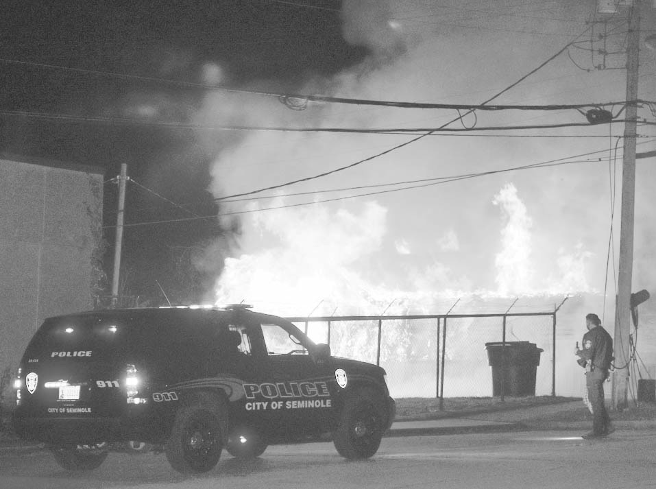 A house on Oak Street, just north of Broadway, went up in flames early Saturday evening shortly after the start of the Seminole Christmas Parade. Investigators say the blaze was considered arson, and one arrest has been made. (Staff photo by Andy Wilson)