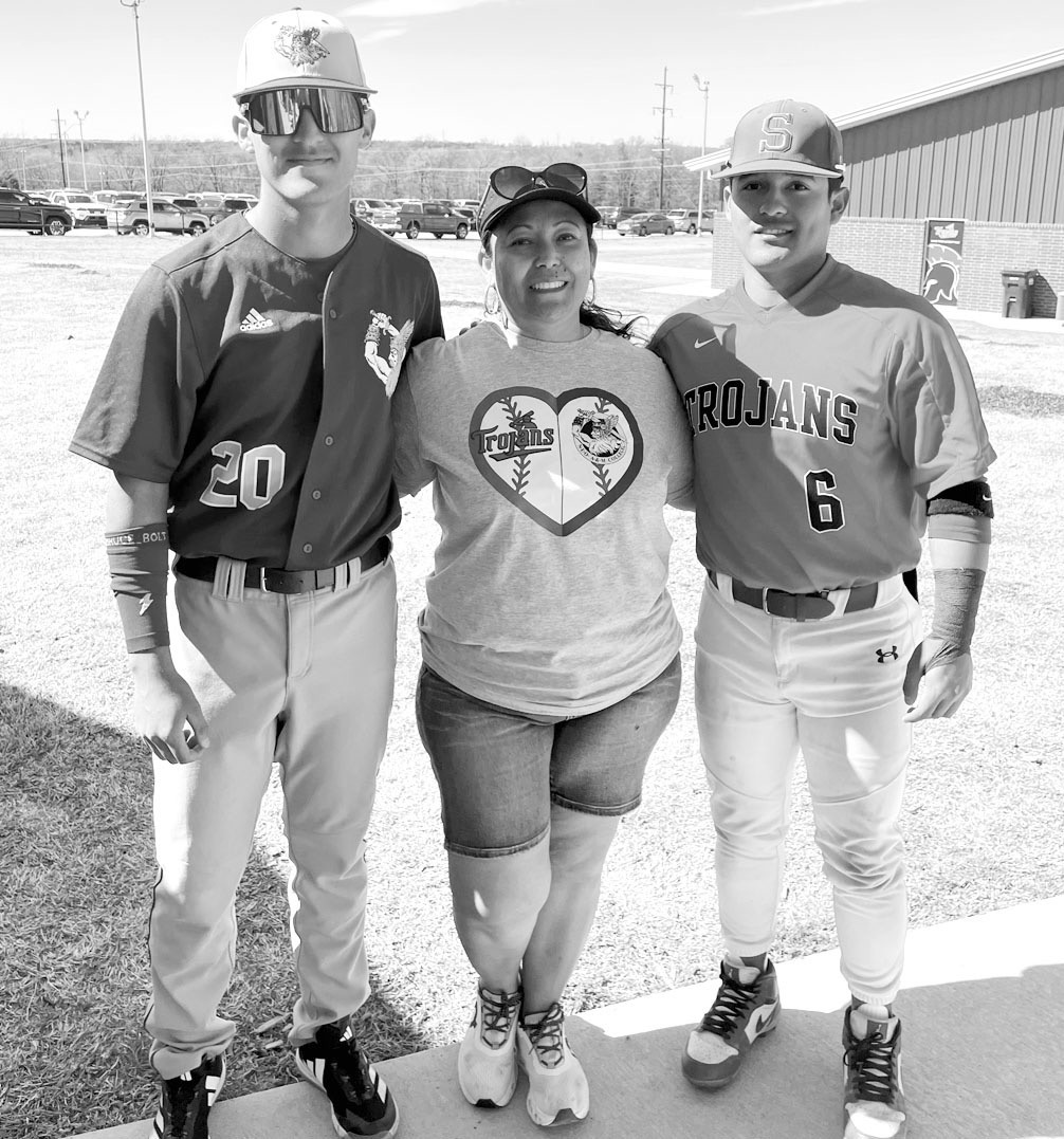 Adriana Tiscareno (center) didn’t have to choose teams when Seminole State played Northeastern Oklahoma A&amp;M this past weekend. Her son Jose (left) plays for NEO and her son Angel plays for Seminole. Rosa showed up in a shirt with both team logos on 