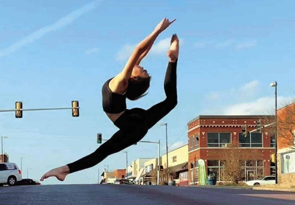 In this file photo from 2021, Alayna Rodriquez leaps across Main Street as a reminder to “spring forward” this weekend. Daylight Saving Time begins at 2 a.m. Sunday, so clocks need to be moved ahead by one hour. —File Photo