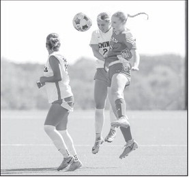 Seminole State Lady Trojan Emma Fanous battles a Lady Buck defender for the ball. Photo by Glen Bryan