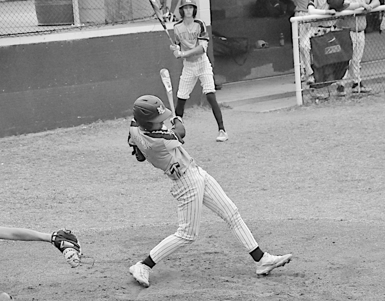 New Lima Falcon Logan Heard drives a ground ball to get on base. Staff Photo by Bill Anderson