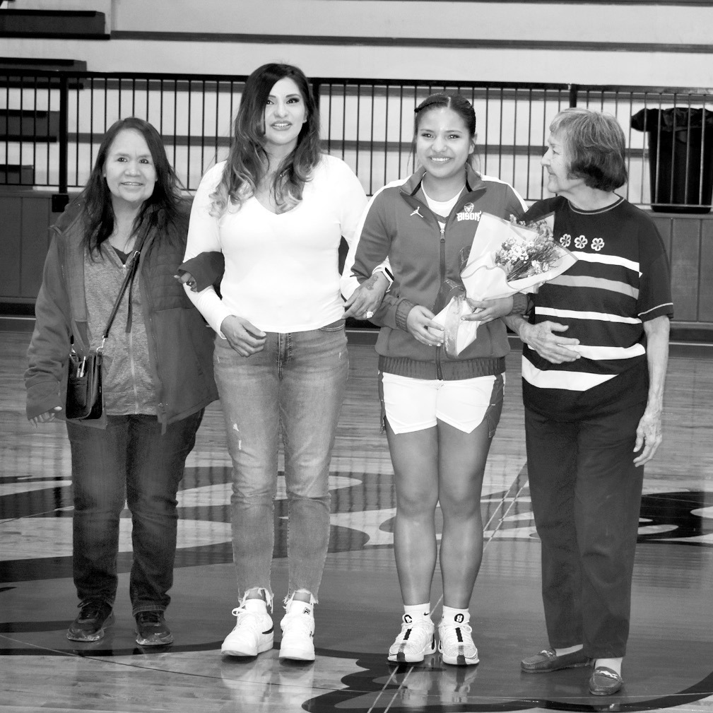 Teyha Coker (second from right), a senior basketball player for the Bowlegs Lady Bison, was honored Friday night before the team’s game against Paoli. Teyha was joined on the court by family members. —Staff Photo by Andy Wilson