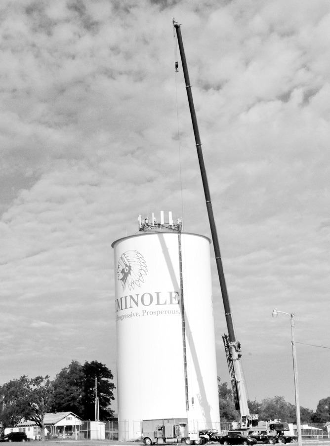 If you spotted a crane hovering over the Highland Street water tower, Cellular One is removing equipment from the top, according to Public Works Director Bryant Baker. —Staff Photo by Bill Anderson
