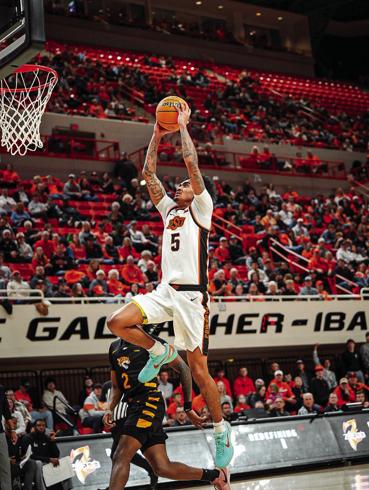 Oklahoma State’s Vyctorius Miller flies in for the easy two. Courtesy Photo by Ben Schatzel