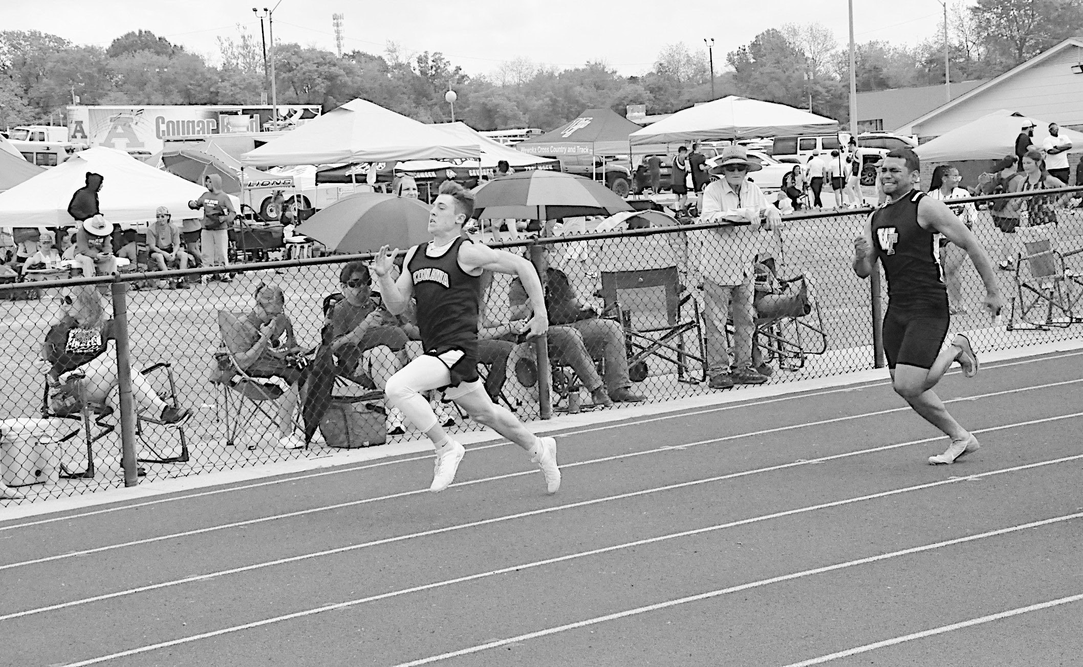 Konawa Tiger Mason Davis sprints to the finish line, followed directly by Wewoka Tiger Mike Piza Friday at Ada. Staff Photo by Bill Anderson