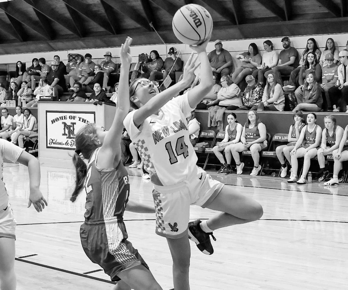 New Lima Falconette Jazzy Harjo gets past Butner’s defender Bella Jones for the layup Friday night. Courtesy Photo by Glen Bryan