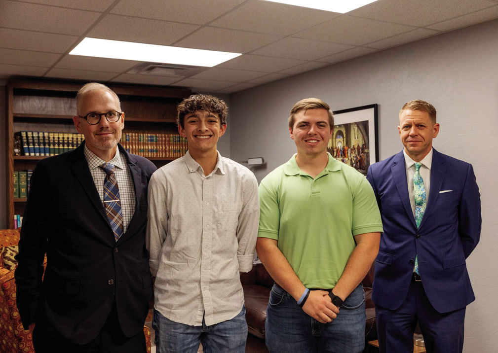 From left, Dr. Ben Myers, director of the Oklahoma Baptist University honors program, is joined by OBU students Zadyn Joplin and Thomas Gage, and Mark Riley, owner of Walker Funeral and Cremation Services. (OBU photo)