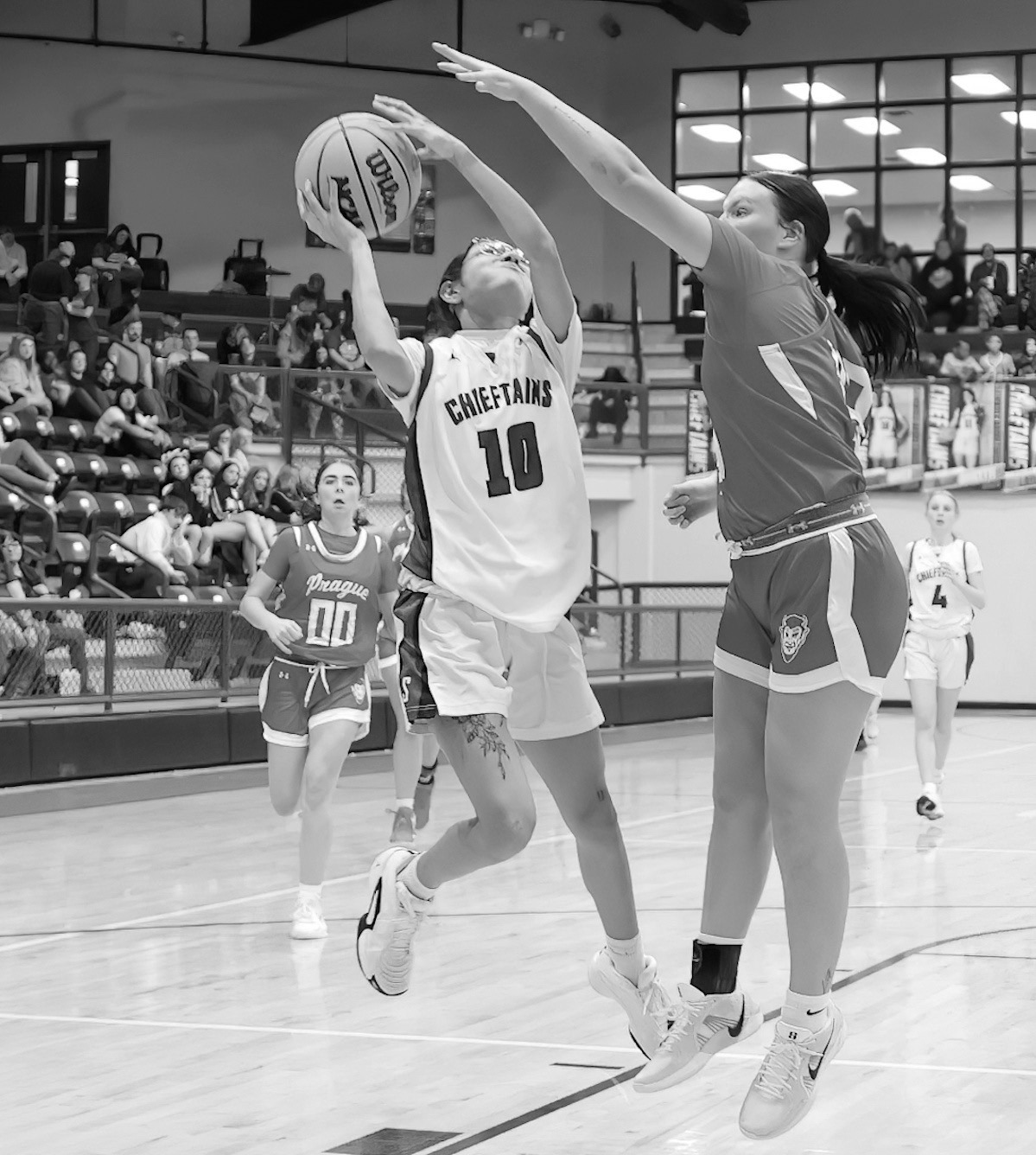 Seminole Lady Chieftain Molli Bustos fights for the shot against the Prague defender Tuesday. Courtesy Photo by Glen Bryan