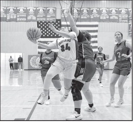Courtesy Photo by Glen Bryan Seminole Lady Chieftain Aundrea Tagg drives down the lane to put up a shot.