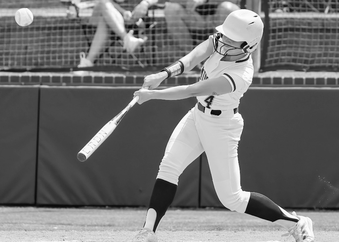 Seminole State Lady Trojan McKayla Greenshaw drives the ball into the outfield Courtesy Photo by Glen Bryan