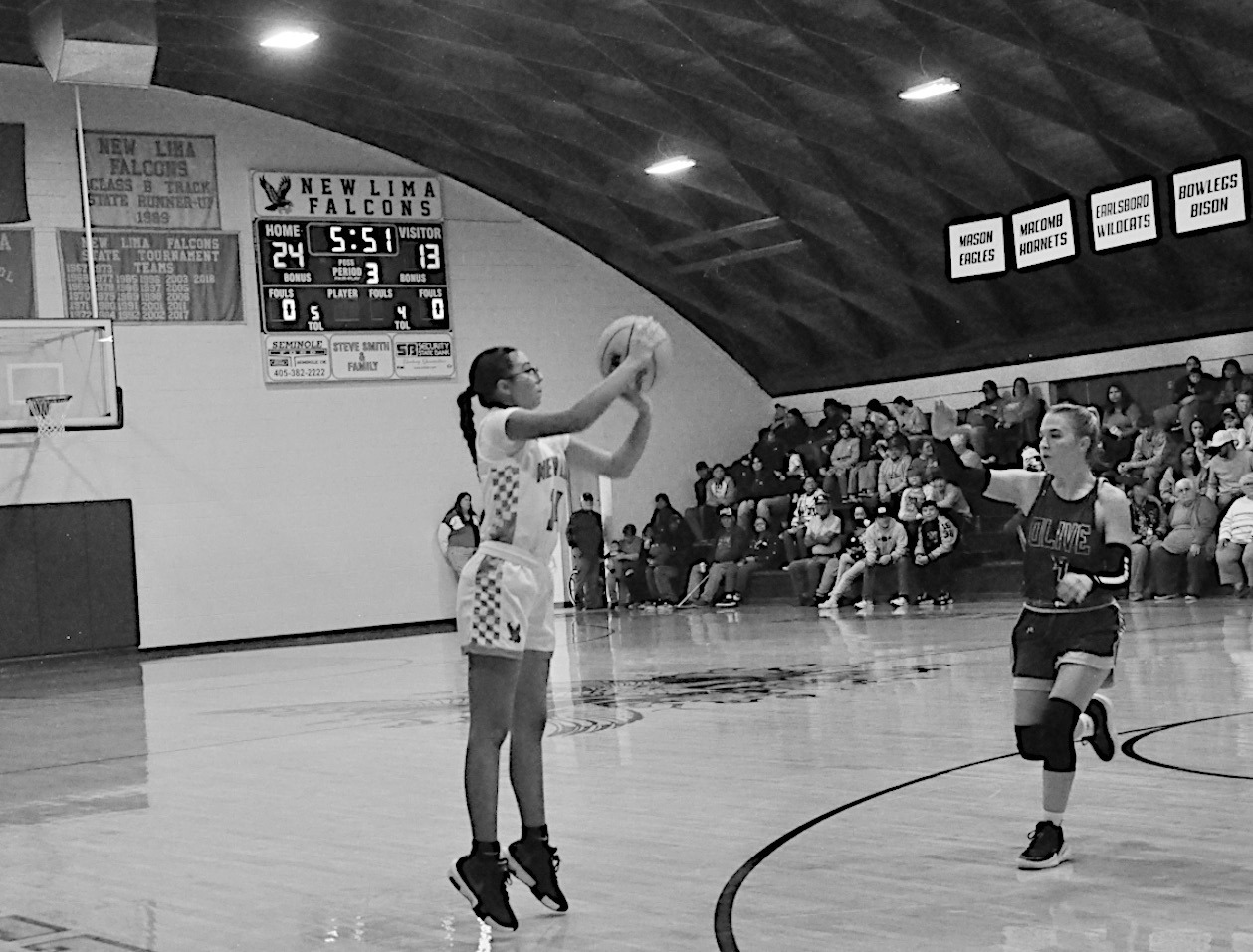 New Lima Falconette Jazzy Harjo shoots one of her many three-point shots Thursday night. Staff Photo by Bill Anderson
