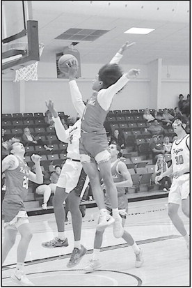 Seminole State Trojan Dylan Golightly fights off the Allen defender for the basket. Staff Photo by Bill Anderson