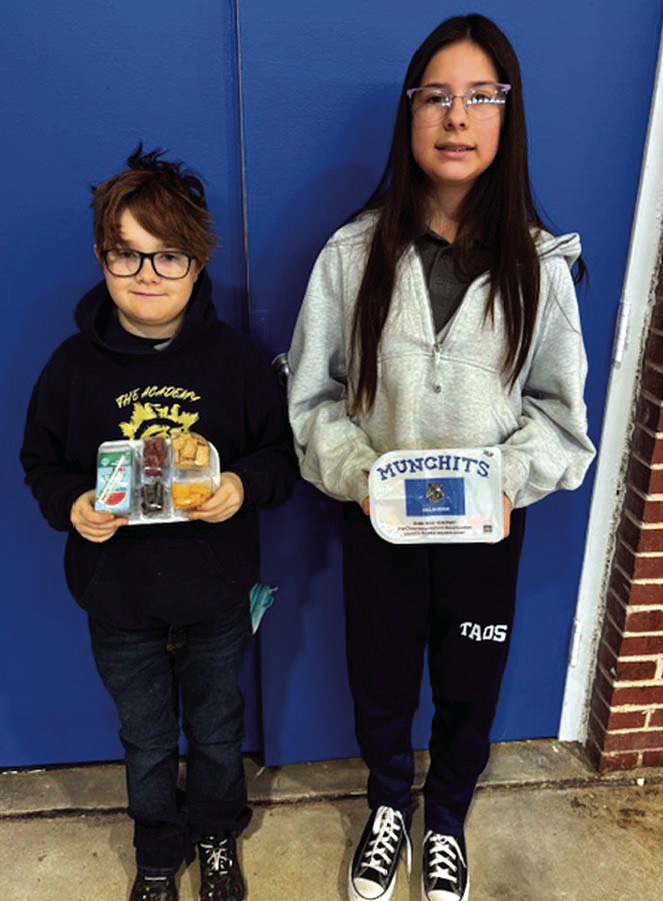 Pictured above are Academy of Seminole students Ryder Gurley and Kodi Lauderdale with samples of meals that are provided through a new partnership between the school and Feed the Children. (Photo courtesy of TAOS).