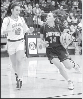 Strother’s Brooklyn Turner eyes the basket as she tries to get past Konawa’s Laila Wroolie. Courtesy Photo by Glen Bryan