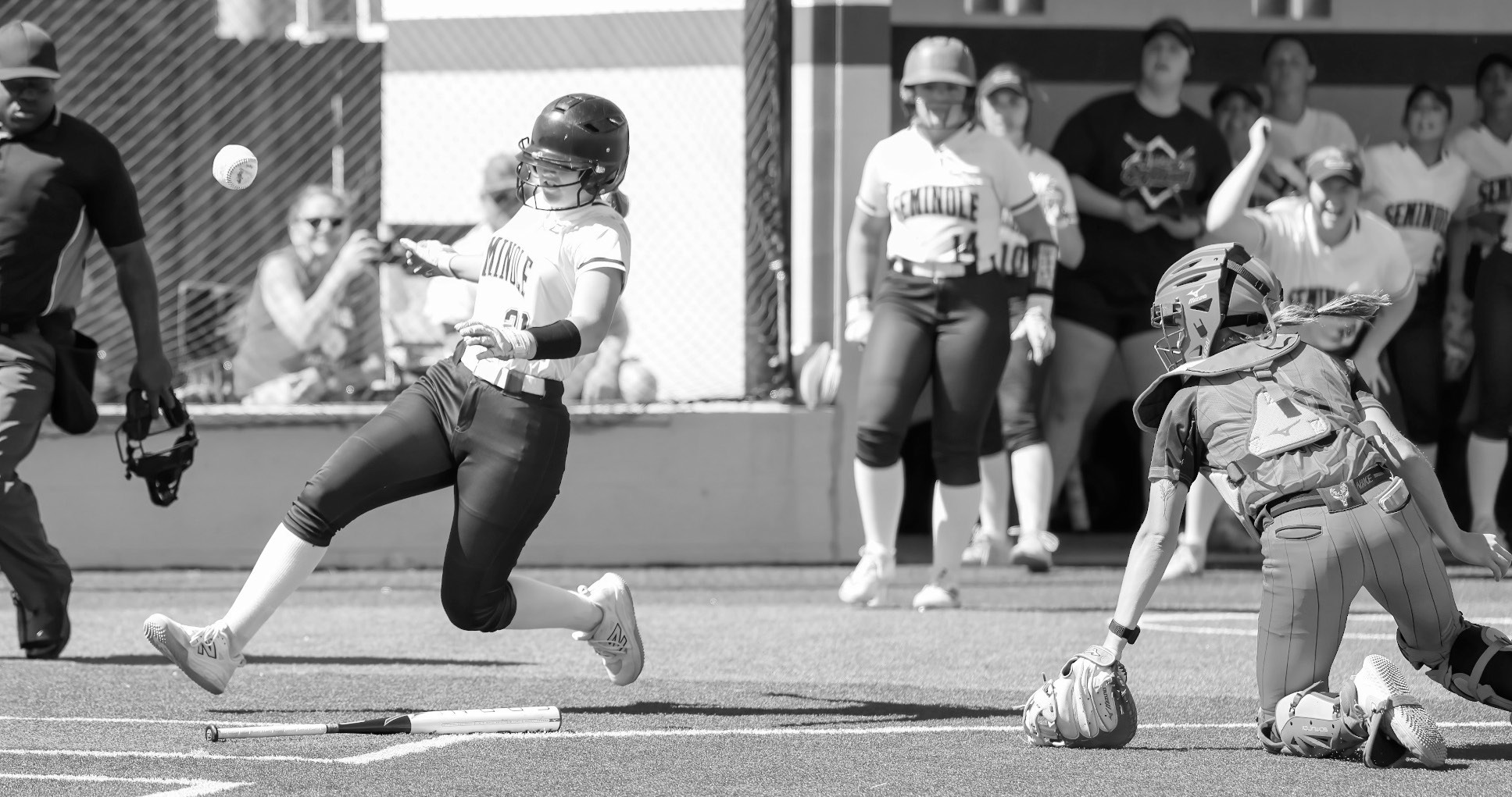 Seminole State Lady Trojan Mckenzier Cothran scores a run as the ball gets past the catcher Monday. Courtesy photo by Glen Bryan