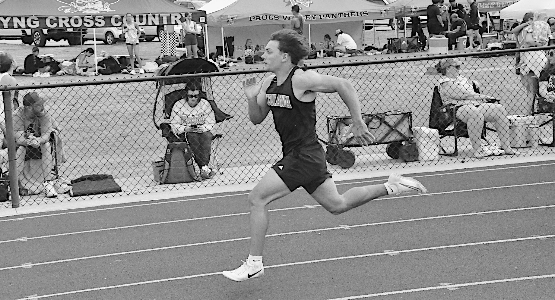 Konawa Tiger Layne Akerman sprints to the finish line in first place in the 100M Friday. Staff Photo by Bill Anderson
