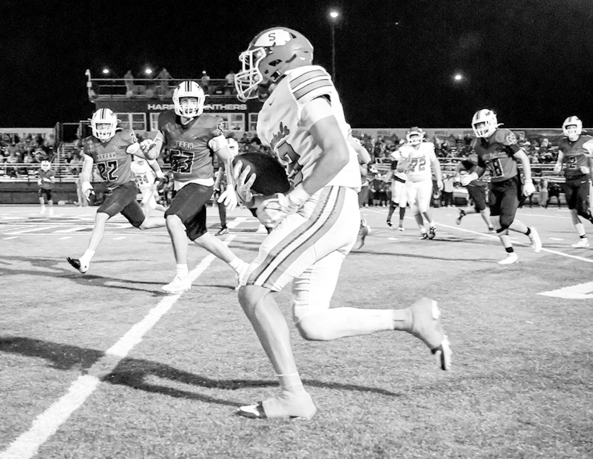Seminole’s Tre Johnson looks for open space Friday night against Harrah. (Photo by Ben Schatzel)