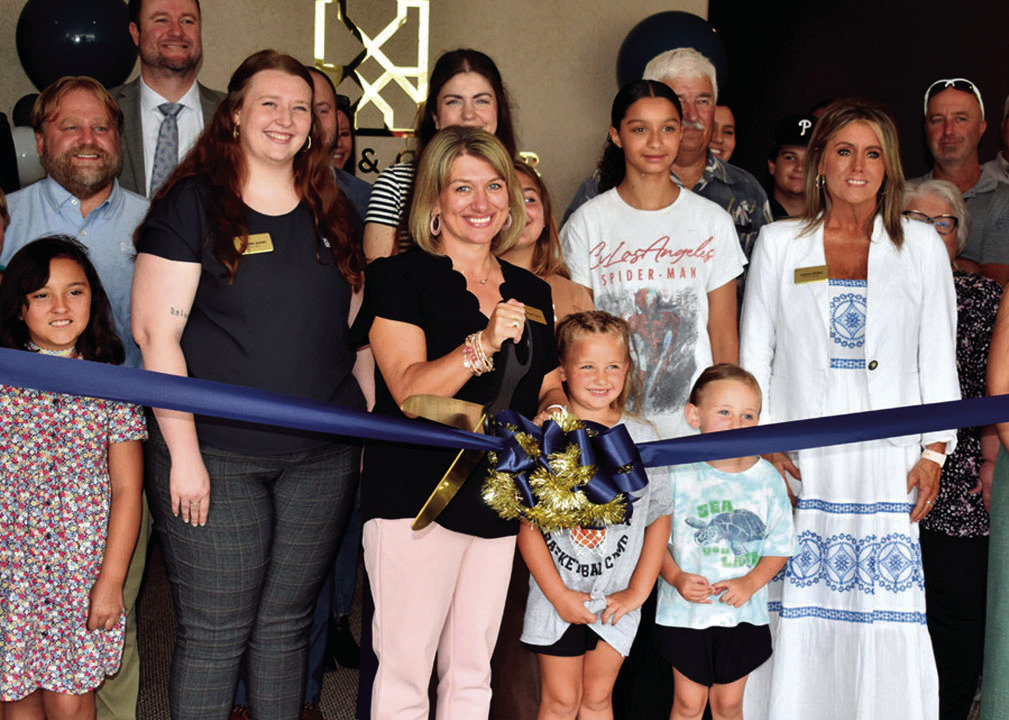 Tanya Friend of Stuart &amp; Clover Title in Seminole cuts the ribbon during open house ceremonies Wednesday afternoon. Others pictured include Dakota Jones, Mila Meeks, Wilo Meeks and Juliana States. The company is located at 205 N. Main. —Staff Photo 