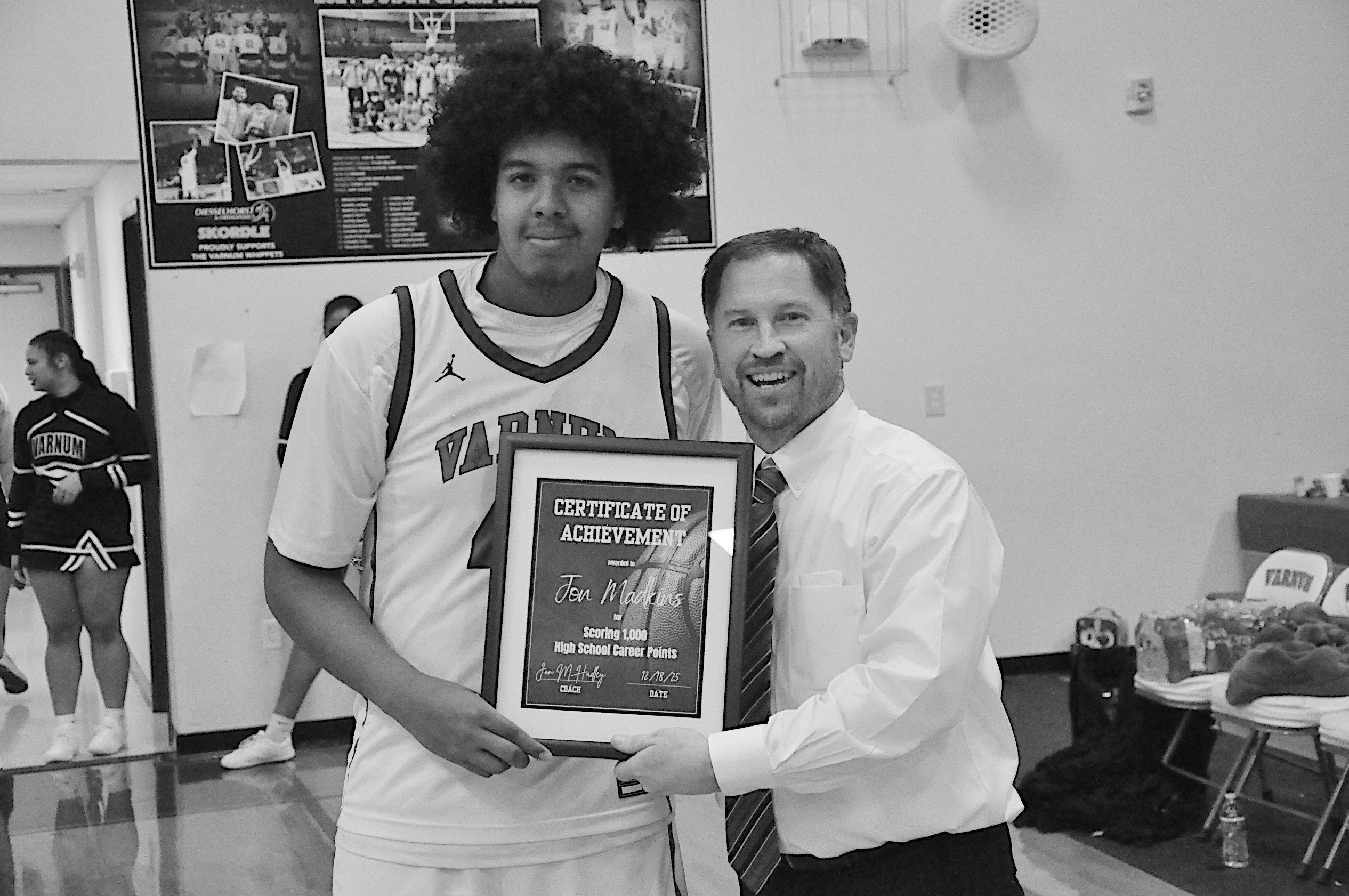Varnum Whippet Jon Madkins (pictured with Head Coach Jon Hadley) reached his 1,000th point mark in his basketball career on December 6th during the LRC Tournament. Madkins was honored Thursday night. Staff Photo by Bill Anderson
