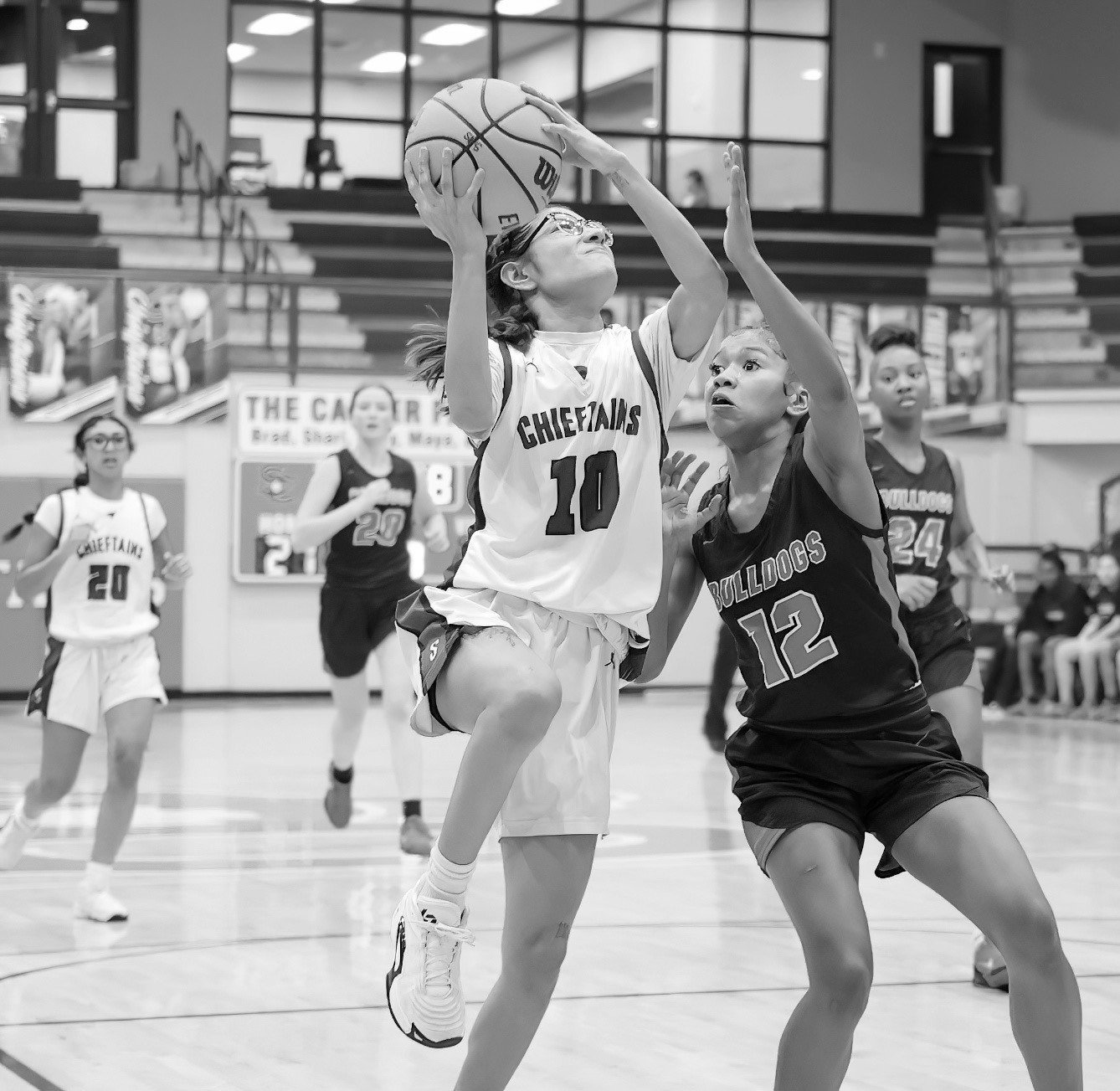 Seminole Lady Chieftain Molli Bustos puts up a basket attempt over an Okmulgee defender Courtesy Photo by Glen Bryan