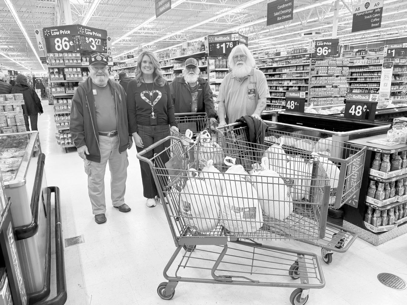 Meal Prep —Courtesy photo American Legion Post 204 donated 20 turkeys to support the Rotary Christmas Dinner. Pictured are American Legion members Harris Thacker, Robert Gatzke and Carl Odom with Angela Willmett, Rotarian and Asst. Superintendent of Sem