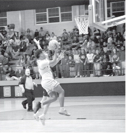 Wewoka Tiger Trae Woods drives in for the basket in last Thursday’s game against the Warner Eagles. Wewoka win the Class 2A, District 4 Championship with a final score of 62-52. (Staff photo by Bill Anderson)