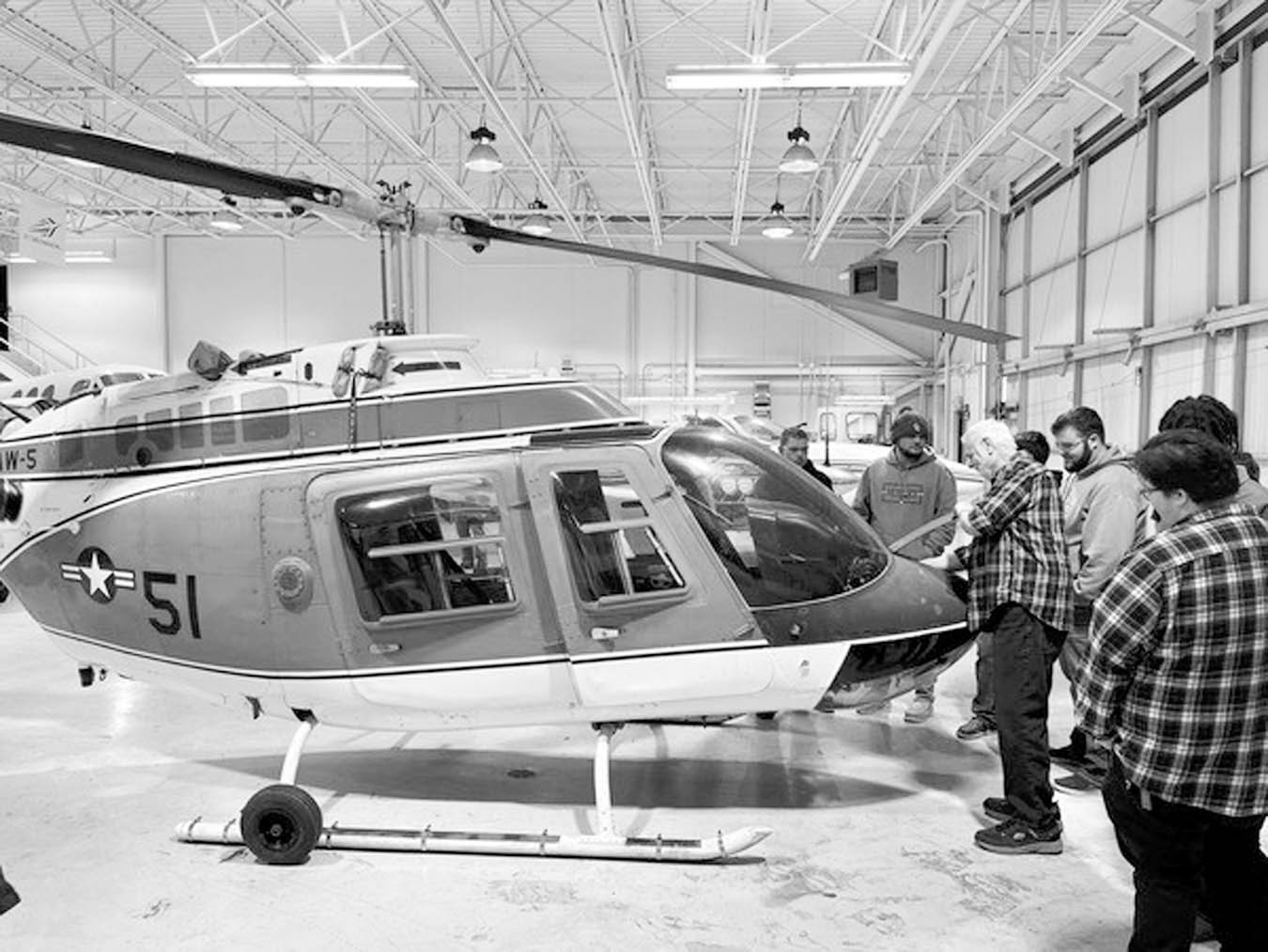 Gordon Cooper Technology Center students and staff observe their new helicopter, acquired through the Oklahoma Federal Surplus program. (Photo provided)