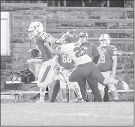 Bowlegs Bison QB Tylar Lee uses a stiff arm to get by a Paoli defender. Courtesy Photo by Glen Bryan