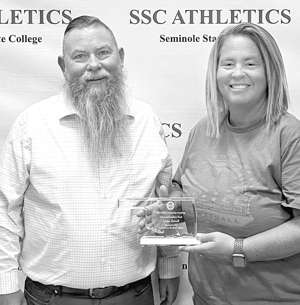 Seminole State College Vice President for Academic and Student Affairs Dr. Bill Knowles (left) presents Athletic Director Leslie Sewell (right) with a plaque recognizing her completion of the Advanced Leadership Track of the 2024-2025 Council on Student A