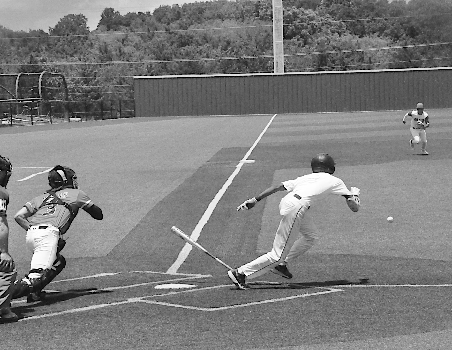 Diamond Dawgs player bunts the ball and races to first base Friday afternoon during Showdown. Staff Photo by Bill Anderson