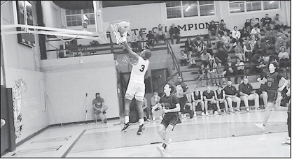 Wewoka Tiger Bill Stephens flies in for the layup Monday night against Vanoss. Wewoka Tigers won 67-60. Staff Photo by Bill Anderson