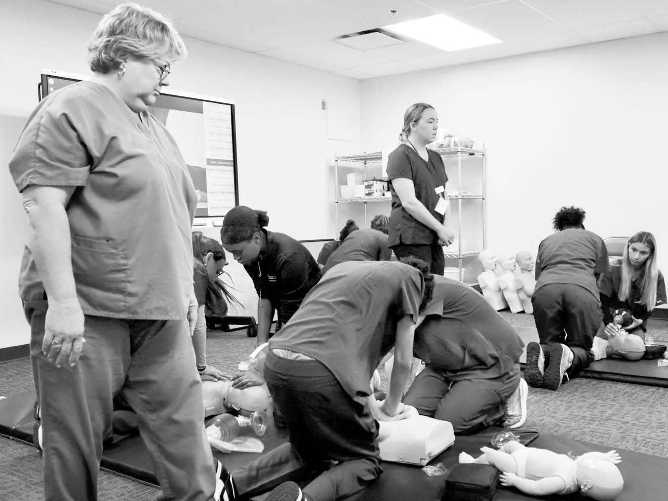 Students in the certified nursing assistant program at Francis Tuttle’s Rockwell campus practice CPR skills while instructors supervise and offer guidance on Sept. 5, 2025. (Photo by Emma Murphy/Oklahoma Voice)