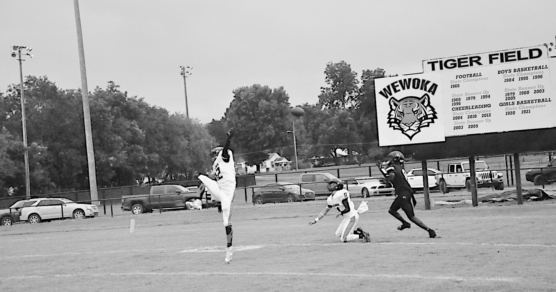 Staff Photo by Bill Anderson Konawa Tiger Layne Akerman tips the ball into the hands of Wewoka Tiger Bill Stephens for the touchdown Friday.