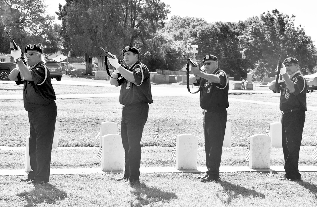 Left, members of the Seminole Nation Honor Guard fire a three-volley salute in honor of fallen military members at Maple Grove Cemetery Monday Morning. The salute was part of the Annual Memorial Day Service, sponsored by the Maple Grove Cemetery Chapel Association. Below left, Brody Haley plays “Taps” and the First United Methodist Church Joybells play the song “America” during the service. —Staff Photos by Andy Wilson
