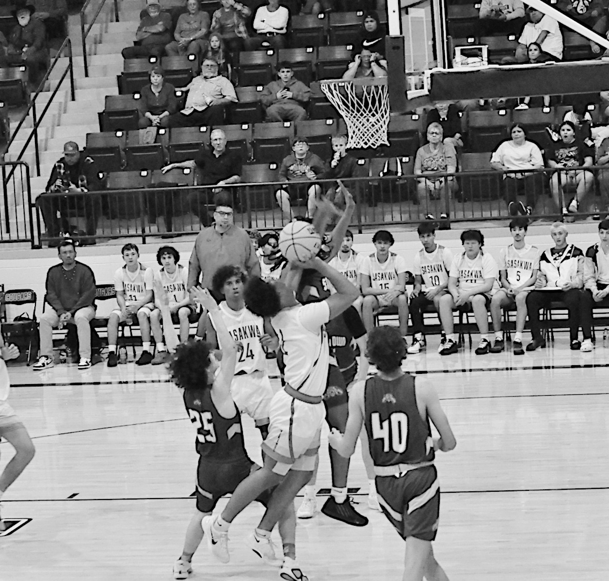 Sasakwa Viking Sherman Mitchell goes in between two defenders for the basket Thursday. Staff Photo by Bill Anderson