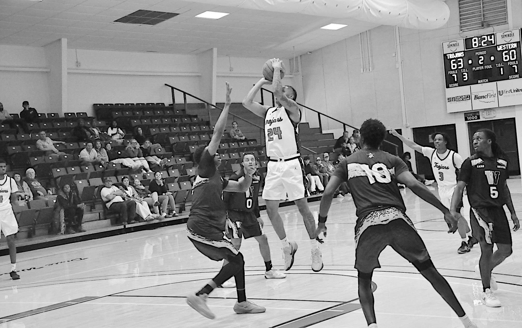 Seminole State Trojan Jamarri Simpson makes the jump shot over the Western Oklahoma State College defender Monday night. Staff Photo by Bill Anderson