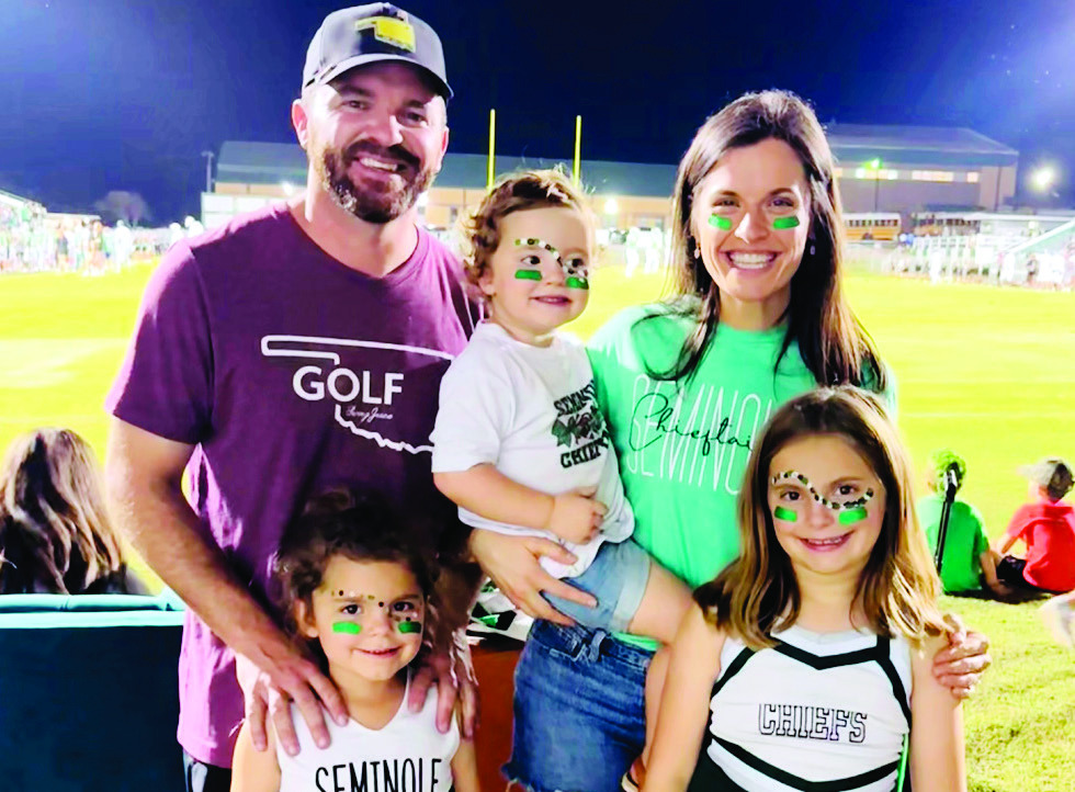 Above, Tyler Geohagan with his wife, Dr. Jenna Geohagan and children, Nora, Maya and Ella at a Seminole Chieftain football game. Tyler has announced his candidacy for the soon to be open seat on the Seminole Public Schools Board of Education. The election