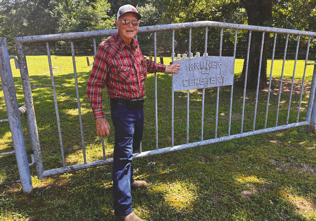 Eighty-nine-year-old Billy Joe “BJ” Isaacs, a graduate of Konawa High School, at the gate of Bruner Cemetery in Seminole County. Isaacs has been anonymously maintaining for the cemetery for more than two decades. —Photo by Bob Melton